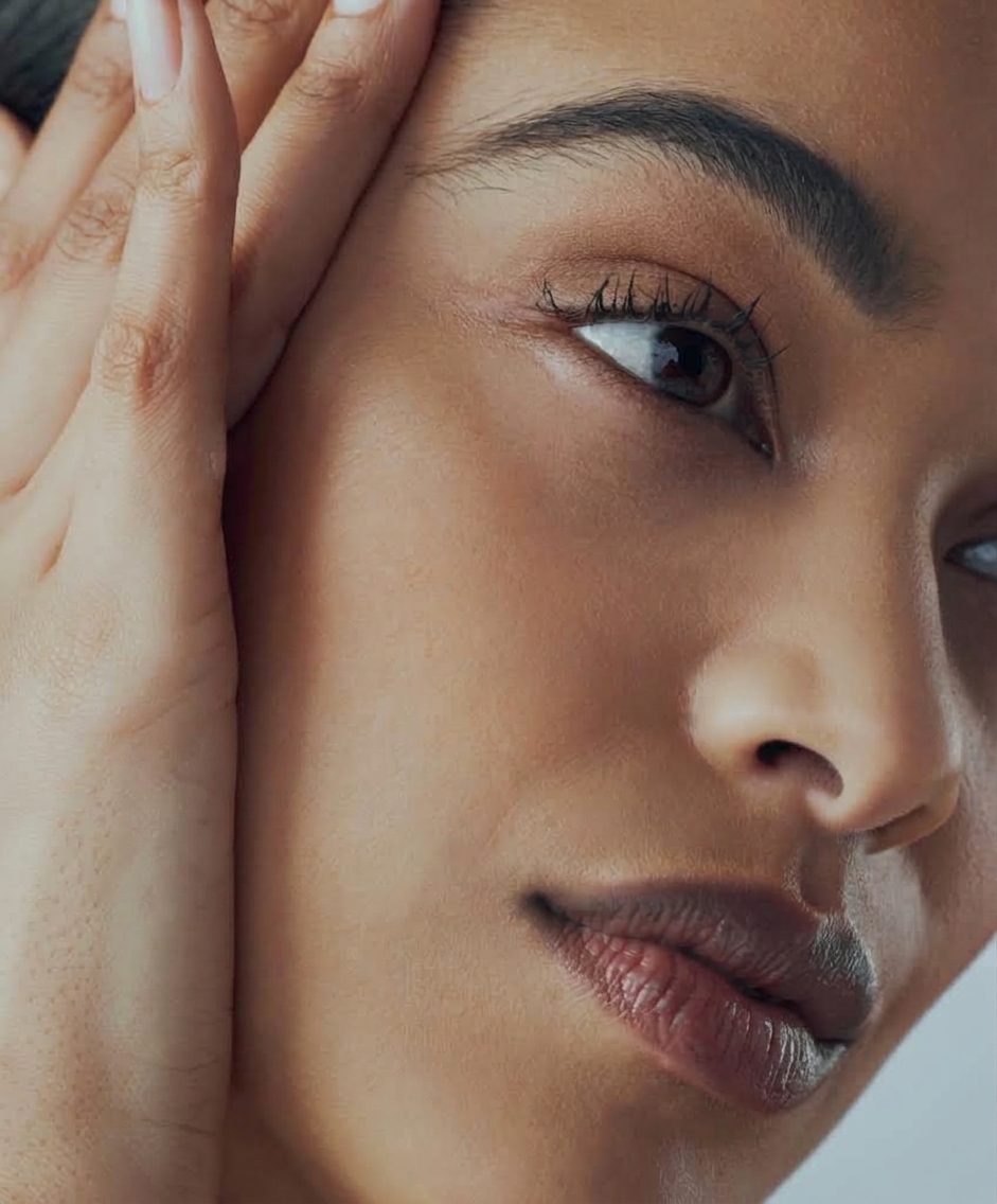 Close-up of a woman's face with radiant skin showing the results of a Julaine skin renewal treatment.